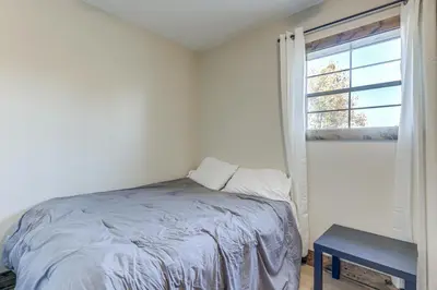 a white bedroom with a bed and a window at Patio and Views Country Getaway in Bluegrass Region in Carlisle