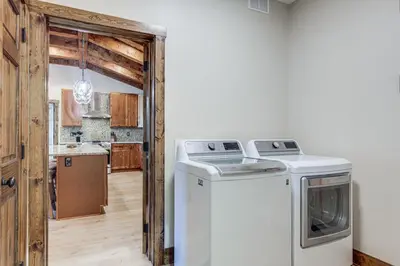 a kitchen with a washer and dryer in a room at Patio and Views Country Getaway in Bluegrass Region in Carlisle