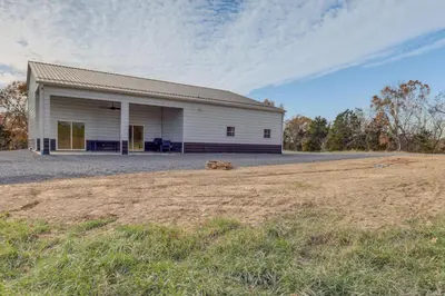 a large white building with a field in front of it at Patio and Views Country Getaway in Bluegrass Region in Carlisle