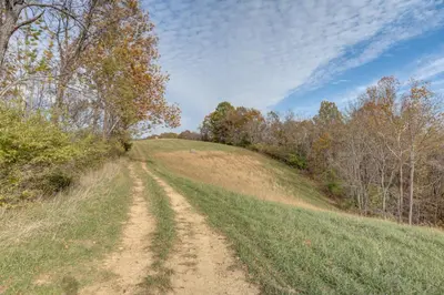 a dirt road in the middle of a field at Patio and Views Country Getaway in Bluegrass Region in Carlisle