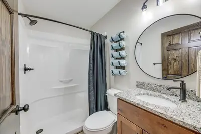 a bathroom with a toilet and a sink and a mirror at Patio and Views Country Getaway in Bluegrass Region in Carlisle