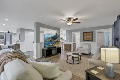 a living room with a couch and a ceiling fan at Colonial on Crane in Buckeye Lake
