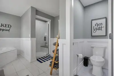 a white bathroom with a toilet and a shower at Colonial on Crane in Buckeye Lake
