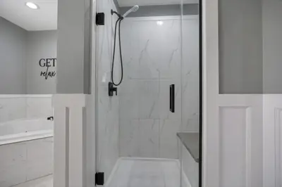 a bathroom with a shower with a glass door at Colonial on Crane in Buckeye Lake
