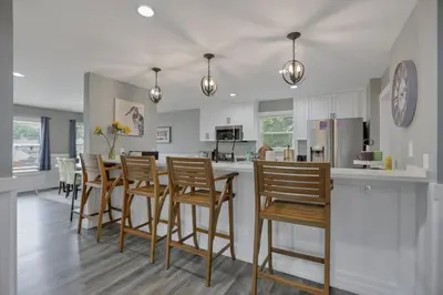 a kitchen and dining room with a table and chairs at Colonial on Crane in Buckeye Lake
