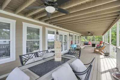 a screened porch with a table and chairs on a house at Colonial on Crane in Buckeye Lake