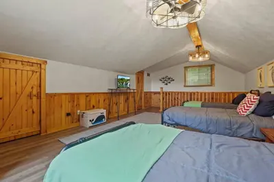 a bedroom with two beds and a tv in it at Lakefront in Logan (In the heart of Hocking Hills) in Logan
