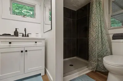 a bathroom with a toilet and a sink and a shower at Lakefront in Logan (In the heart of Hocking Hills) in Logan