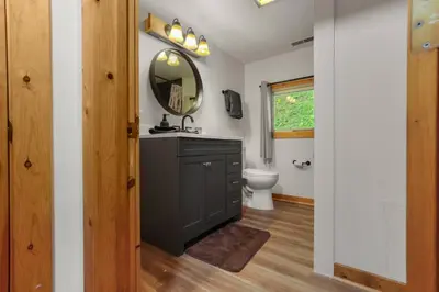 a bathroom with a sink and a mirror at Lakefront in Logan (In the heart of Hocking Hills) in Logan