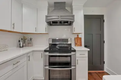 a kitchen with white cabinets and a stove top oven at Adventures at Aspen Way in Rockbridge
