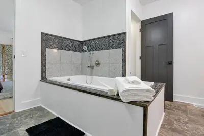 a white bathroom with a tub and a shower at Adventures at Aspen Way in Rockbridge