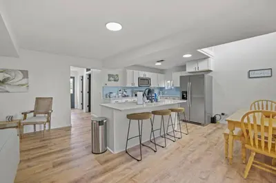 a kitchen with a counter and bar stools in it at Luxury on Lakeside