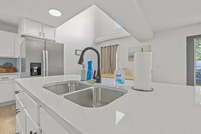 a kitchen with a sink and a counter top at Luxury on Lakeside