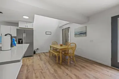 a kitchen and dining room with a table and chairs at Luxury on Lakeside