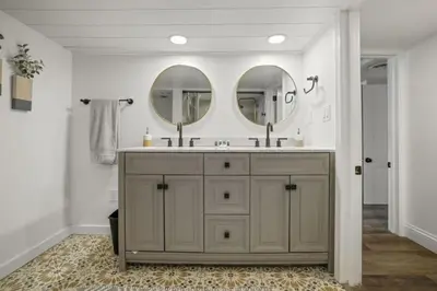 a bathroom with a sink and two mirrors at Good Vibes Only in Thornville