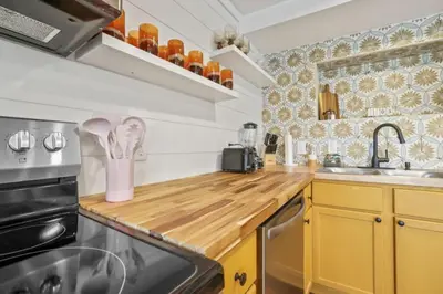 a kitchen with yellow cabinets and a wooden counter top at Good Vibes Only in Thornville
