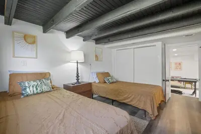 a bedroom with two beds and a table in it at Good Vibes Only in Thornville
