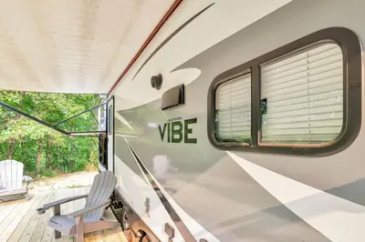 a train car with a window and a chair at Chestnut Camper in Lancaster
