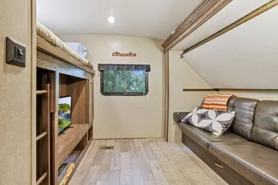 a living room with a leather couch in a tiny house at Chestnut Camper in Lancaster