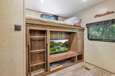 a living room with a tv in a rv at Chestnut Camper in Lancaster