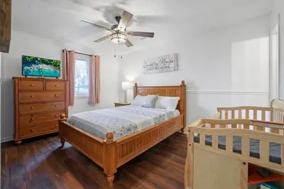 a bedroom with a bed and a ceiling fan at Chicks on Canal