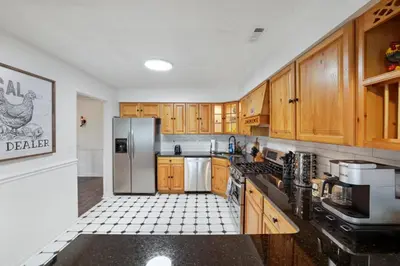 a kitchen with wooden cabinets and a stainless steel refrigerator at Chicks on Canal