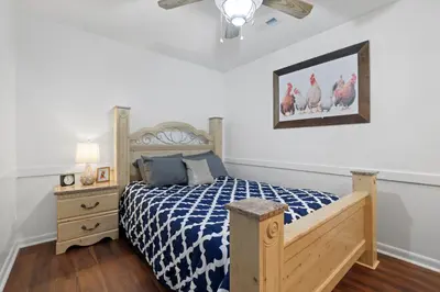 a bedroom with a bed with a blue and white comforter at Chicks on Canal