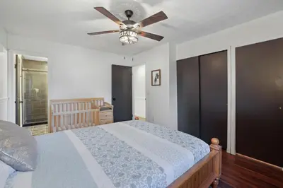 a bedroom with a bed and a ceiling fan at Chicks on Canal