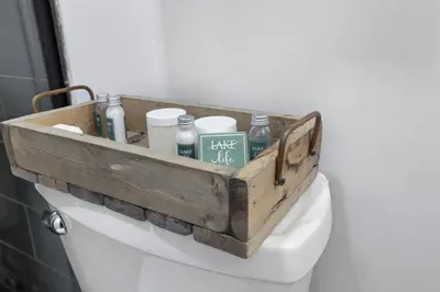 a wooden box on top of a toilet in a bathroom at Chicks on Canal