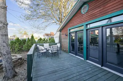 a wooden deck with a table and chairs on it at Chicks on Canal