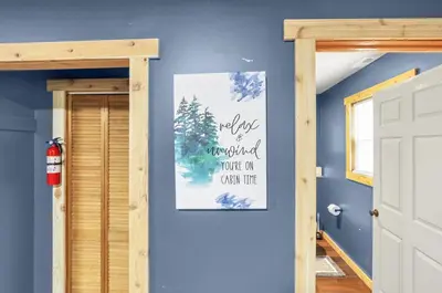 a room with a blue wall with a picture on the wall at The Blue Spruce in Lancaster