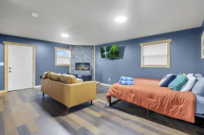 a bedroom with blue walls and a bed and a couch at The Blue Spruce in Lancaster