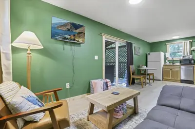 a living room with a couch and a table at The Evergreen Cabin in Lancaster