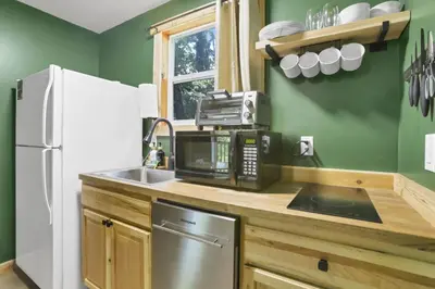 a kitchen with a sink and a microwave at The Evergreen Cabin in Lancaster
