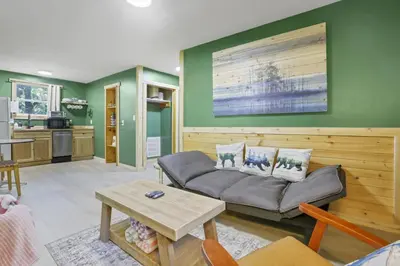 a living room with a couch and a table at The Evergreen Cabin in Lancaster