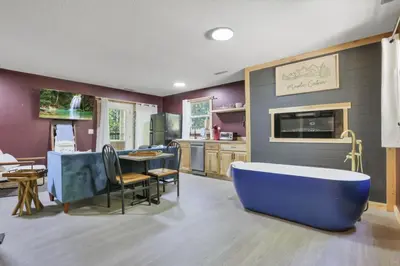 a large bathroom with a blue tub in a kitchen at The Maple Cabin in Lancaster
