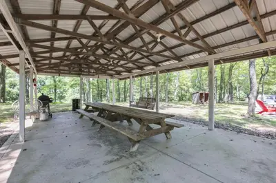 a wooden picnic table sitting inside of a tent at The Maple Cabin in Lancaster