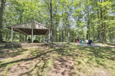 a picnic shelter in the middle of a field at The Maple Cabin in Lancaster