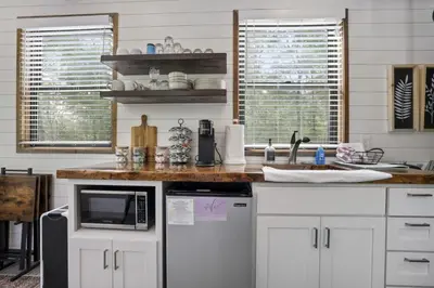 a kitchen with white cabinets and a counter top at Hiltop Haven The Double Stack in Logan