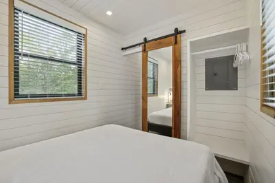 a bedroom with a bed and a window at Hiltop Haven The Double Stack in Logan