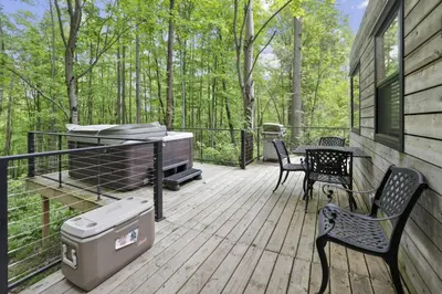 a deck with a grill and a table and chairs at Hiltop Haven The Top Deck in Logan
