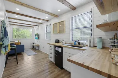 a kitchen with white walls and wooden floors at Hiltop Haven The Top Deck in Logan