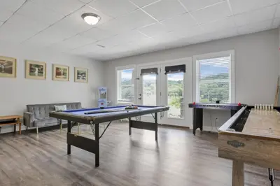 a room with two ping pong tables in it at Serenity on Siverly by Purple Munky Hospitality in McArthur