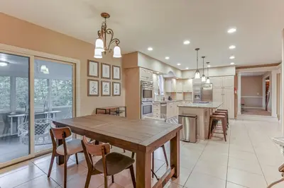 a large kitchen with a wooden table and chairs at Valley View Villa in Lancaster