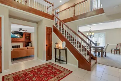 a living room with a staircase and a dining room at Valley View Villa in Lancaster