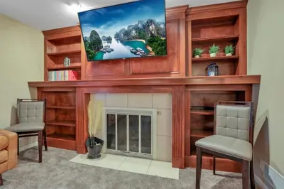 a living room with a fireplace and a flat screen tv at Valley View Villa in Lancaster