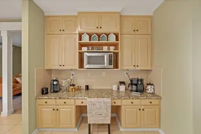 a kitchen with wooden cabinets and a counter with a microwave at Valley View Villa in Lancaster