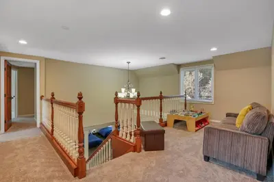 a living room with a staircase and a couch at Valley View Villa in Lancaster