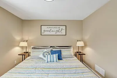 a bedroom with a large bed with blue pillows at Valley View Villa in Lancaster