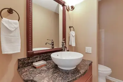 a bathroom with a sink and a mirror at Valley View Villa in Lancaster